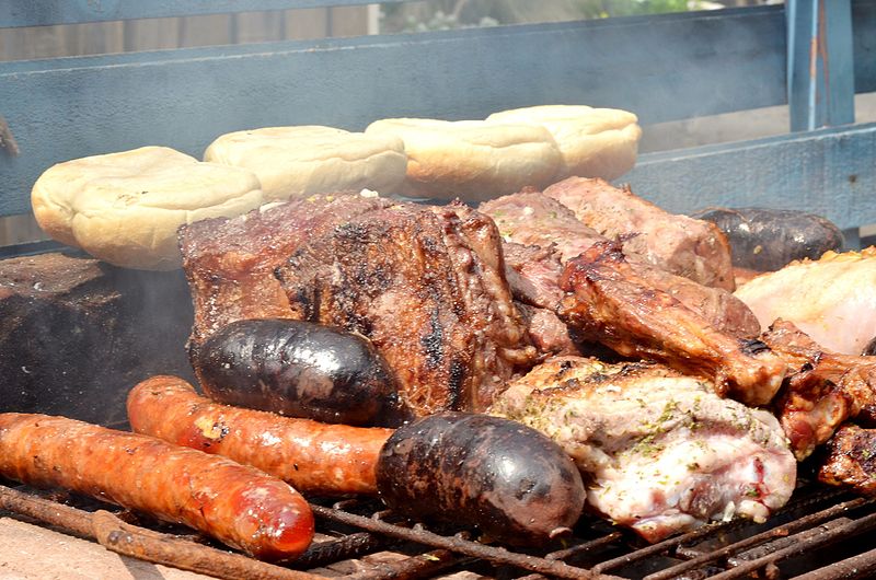 The Chilean inspiration in my romance books: Typical asado grill, with bread, sausages, and big pieces of meat.
