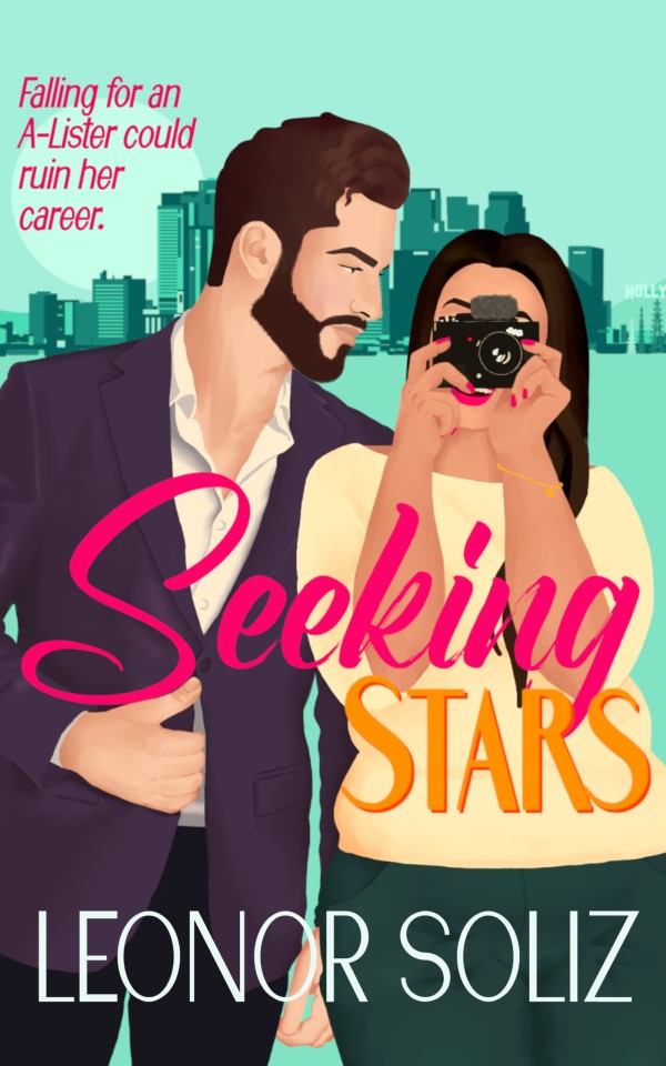 New cover for Seeking Stars. The main characters are in the forefront of the image, with LA in teal in the background. He's wearing a dark purple blazer and is staring at her longingly; she's holding her recording camera in front of her face as if she were recording you. She's wearing a yellow top and dark teal pants. The title of the book stands out in bold pink and orange, and the author's name is at the bottom.