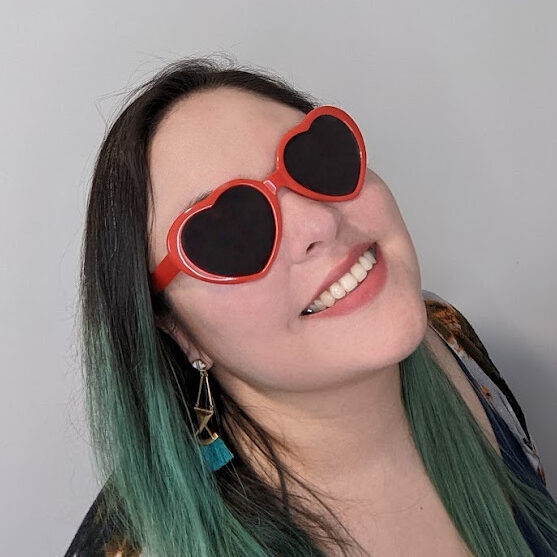 Leonor Soliz smiling and wearing red heart-shaped sunglasses